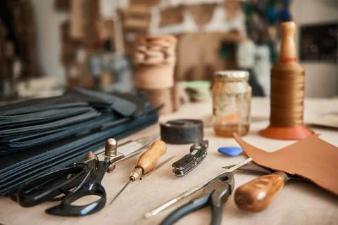 Tools sitting on a bench in a leather workshop Stock Photos