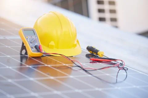 Tools, solar panels or helmet on roof for solar energy installation in a city Stock Photos