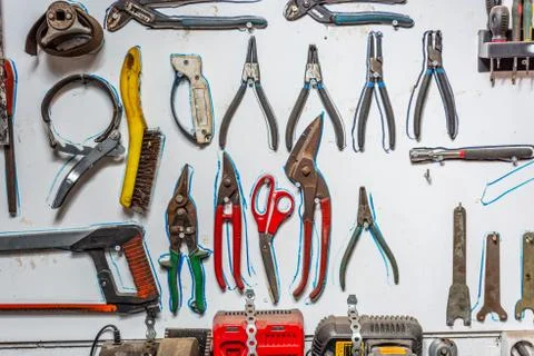 Tools systematically arranged on a wall. Stock Photos