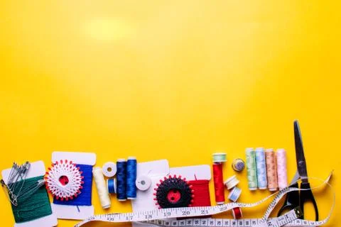 Tools for tailor, instruments for practicing sewing on a yellow background. Stock Photos