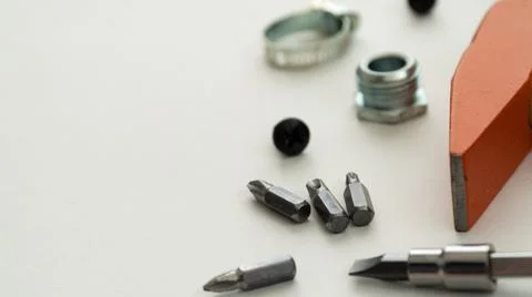 Tools on a white background, close-up of a screwdriver and a bit Stock Photos