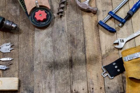 Tools on a wooden table in an old workshop. Arranged on the edge of the table Stock Photos