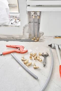 Tools for Work As A Plumber. Connection heating pipes to white Radiator in a new Stock Photos
