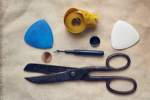 Tools for working with fabric. Scissors, chalk, measuring tape, buttons, flat Stock Photos