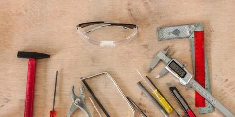 Tools in workshop on wooden background Stock Photos