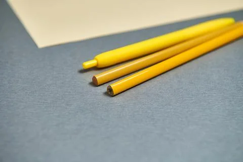 Tools for writing exhausting next to a piece of paper on a gray surface. Stock Photos