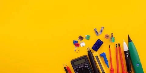 Tools on a yellow background screwdriver, tester, tracker. Stock Photos