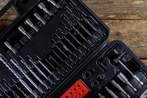 Toolset square black tool box on wooden texture background. Top view Stock Photos