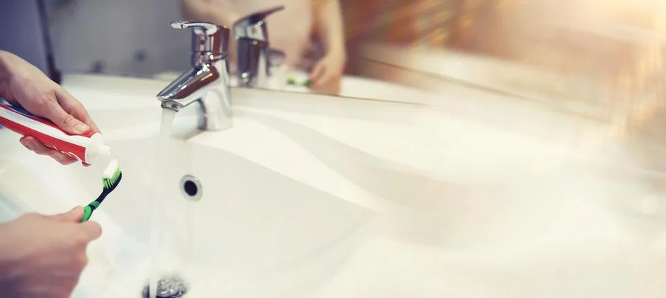 Tooth brush and paste with mirror background in the bathroom. Close up of t.. Stock Photos