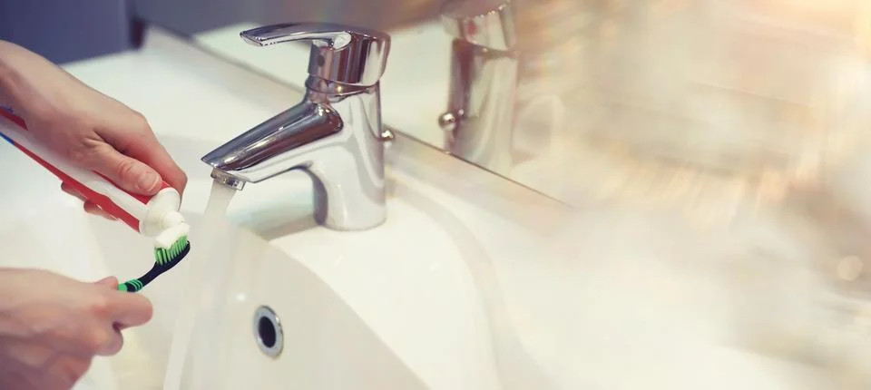 Tooth brush and paste with mirror background in the bathroom. Close up of t.. Stock Photos