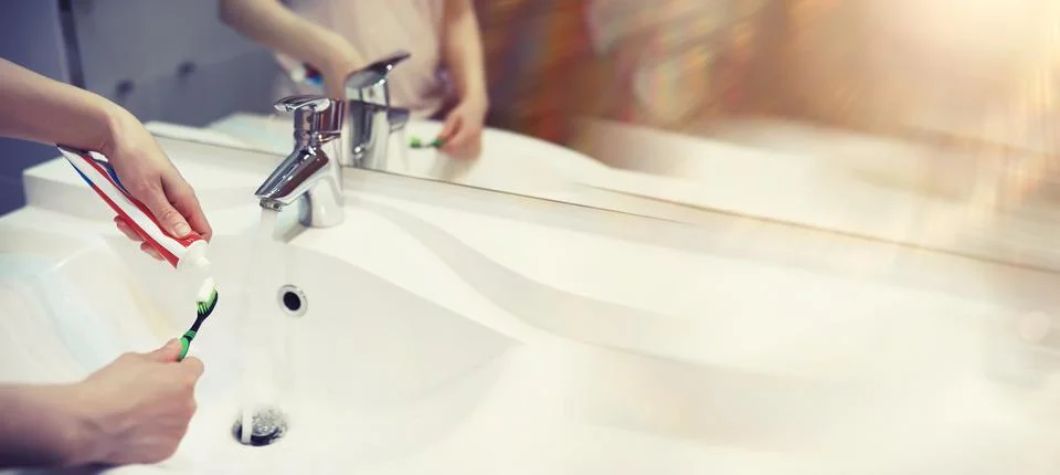 Tooth brush and paste with mirror background in the bathroom. Close up of t.. Stock Photos