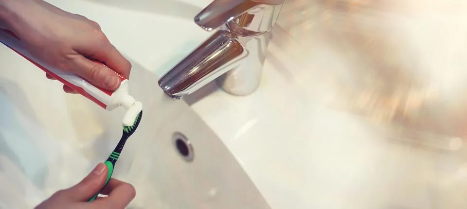 Tooth brush and paste with mirror background in the bathroom. Close up of t.. Stock Photos