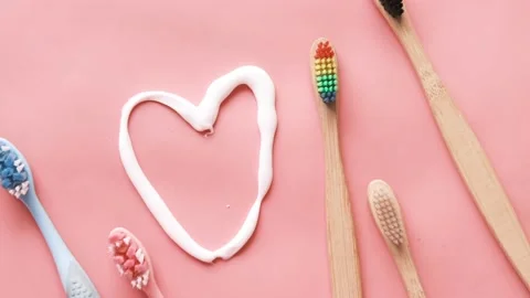 Tooth brush and paste on pink Stock Footage 158884288