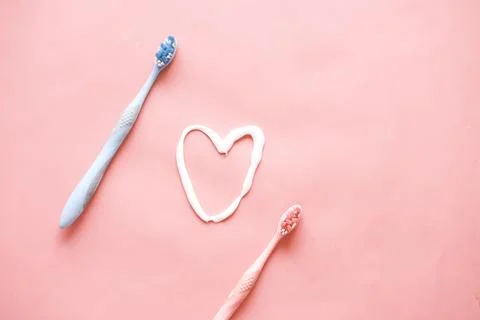Tooth brush and paste on pink background Stock Photos