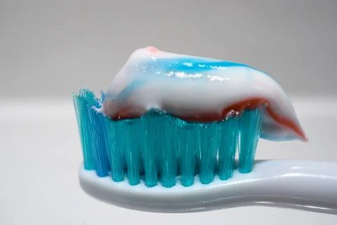 Tooth brush and toothpaste on blurred background. Stock Photos