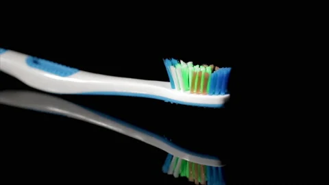 Tooth brush close up. Standard tooth brush bristles close up isolated on black b Stock Footage 166328190