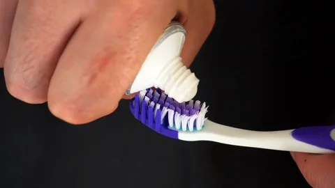 Tooth brush with tooth paste on black background Stock Footage 76630678