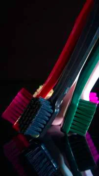 Tooth brushes close up isolated on the darck background. Stock Photos