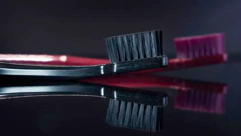 Tooth brushes close up isolated on the darck background. Stock Photos
