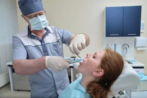 Tooth Extraction procedure with forceps, closeup portrait of woman patient Stock Photos