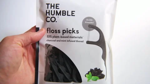 Tooth floss pick picks in plastic bag, dental oral hygiene product Stock Footage 316511083