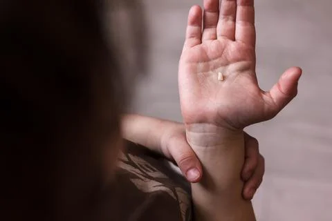 Tooth in a hand after extraction on white background, lost your tooth Stock Photos