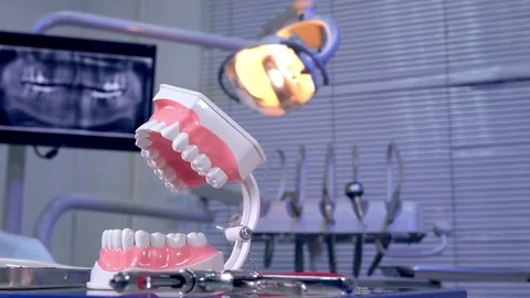 Tooth model instruments on the dentist table and panoramic x-ray image in the Stock Footage 72787433
