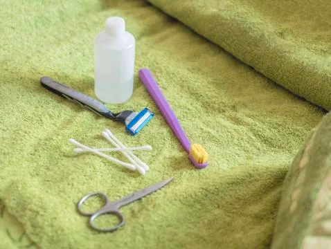 Tooth rinse bathroom accessories on the towel, razor, tooth brush and scissor Foto stock