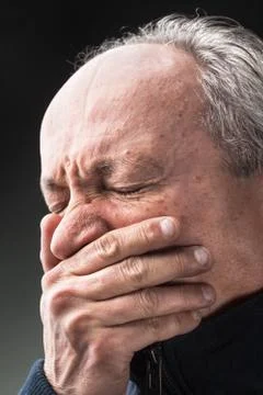 Toothache, elderly man with face closed by hand Stock Photos