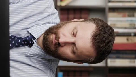 Toothache. Vertical orientation of bearded man in workplace, he experiences Stock-Footage 132729091