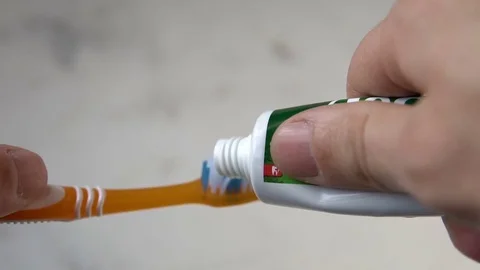 Toothbrush and toothpaste on blurred background Stock Footage 85057234