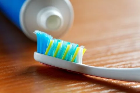 Toothbrush and toothpaste closeup on table Stock Photos