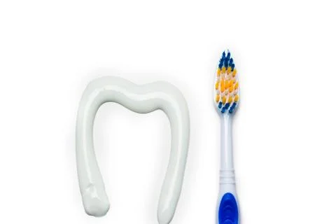 Toothbrush and toothpaste in the form of a tooth white background Stock Photos