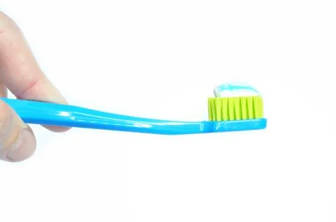 Toothbrush and toothpaste in hand, isolated 写真素材