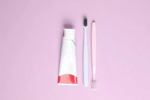 Toothbrush and toothpaste on pink background Fotos Stock