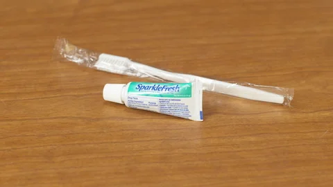 Toothbrush and Toothpaste on Table Stock Footage 164865651