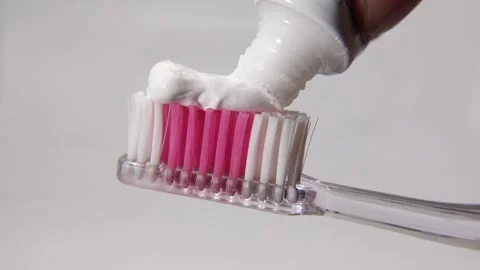 A toothbrush being readied with toothpaste. Stock Footage 313986001