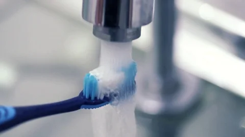 Toothbrush being washed in slow motion Stock Footage 76354936