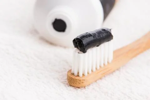 Toothbrush with black charcoal toothpaste Stock Photos