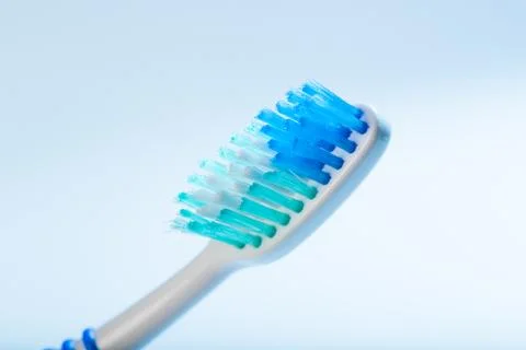 Toothbrush on an blue background, close up Stock Photos