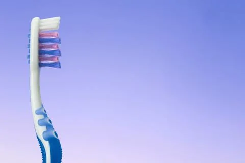 Toothbrush on blue background Stock Photos