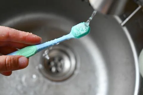 A toothbrush with a blue toothpaste Stock Photos