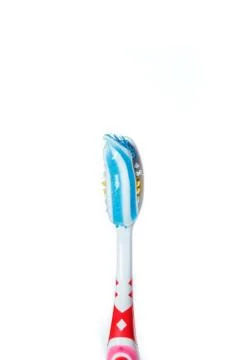 Toothbrush with blue two color toothpaste on light surface Stock Photos