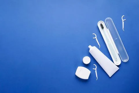 Toothbrush in a case, toothpaste, toothpicks and dental floss with space for  Stock Photos