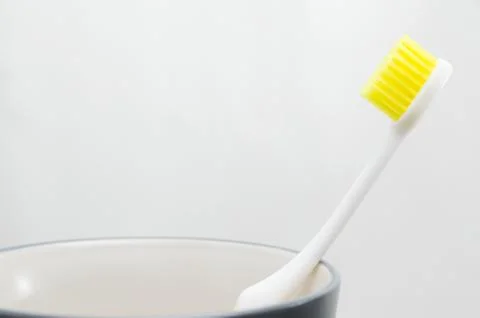 Toothbrush in cup on white background Stock Photos