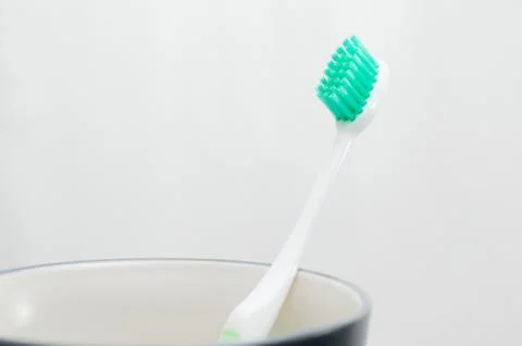 Toothbrush in cup on white background Stock-Fotos