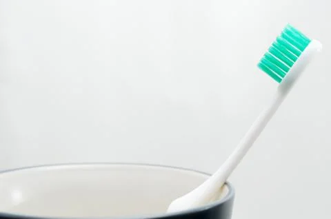 Toothbrush in cup on white background Stock Photos