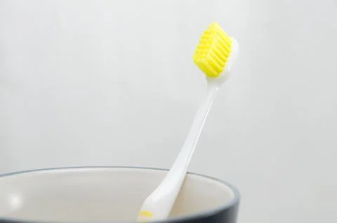 Toothbrush in cup on white background Foto stock