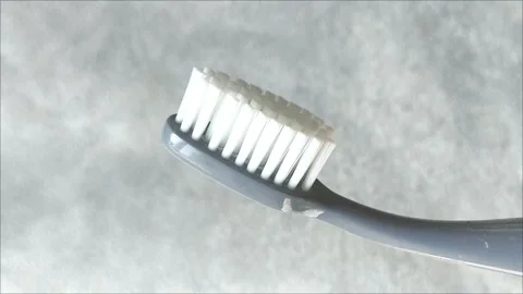 A toothbrush with fine bristles on a gray background in close up Stock-Footage 313356180