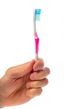 Toothbrush in hand on an isolated background Stock Photos